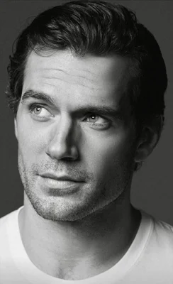 Portrait en noir et blanc d'Henry Cavill en t-shirt blanc.