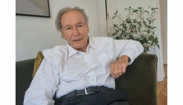 Gérard Brémond, le concepteur de la station d'Avoriaz, assis sur un canapé vert.