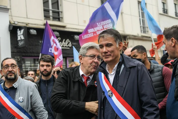 Olivier Faure et un autre responsable échangent lors d'une manifestation politique.