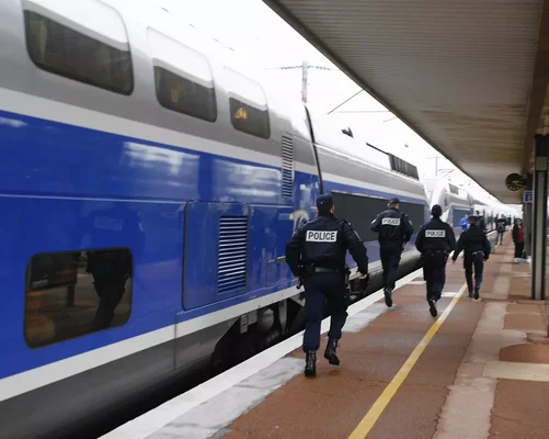 Des policiers courant sur un quai de gare aux côtés d'un TGV lors de l'arrestation.
