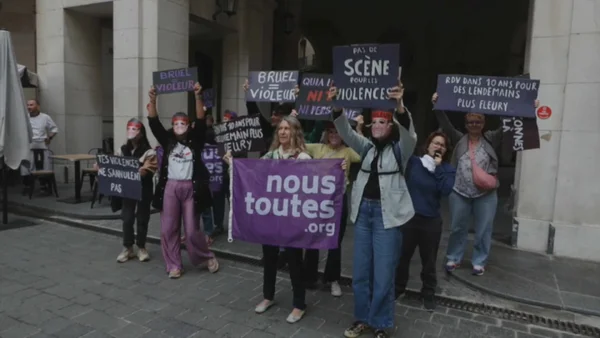 Des manifestantes du collectif #NousToutes brandissent une banderole violette lors de la protestation.