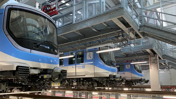 Rames du métro automatique du Grand Paris Express dans un centre de maintenance.