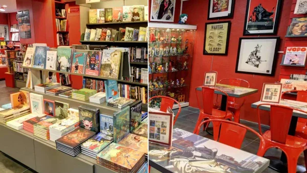 Intérieur d'une librairie indépendante spécialisée en bandes dessinées, avec espace de lecture.