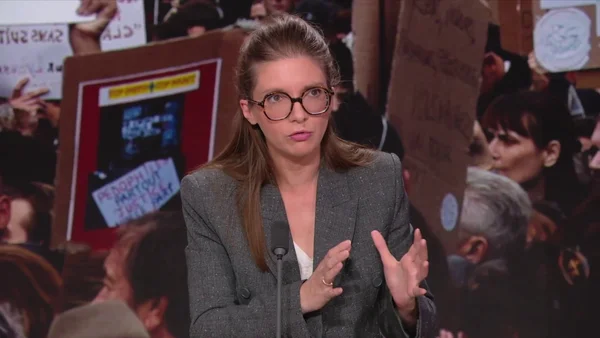 Aurore Bergé s'exprimant au micro devant des manifestants.