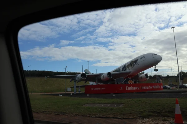Entrée principale de l'aéroport de Heathrow à Londres, avec un avion Emirates A380 en livrée faunique.