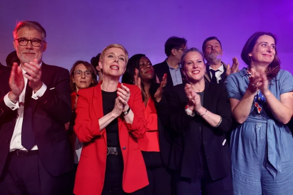 Personnalités applaudissant sur une scène après le vote des sénateurs.