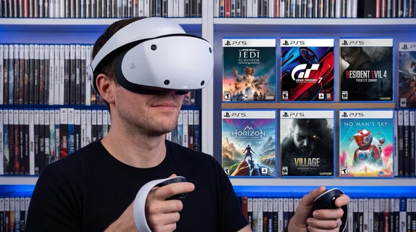 Joueur équipé du PS VR2 devant une collection de jeux physiques, symbole d'une époque qui pourrait s'éteindre.