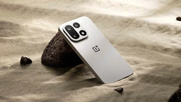 Un smartphone OnePlus blanc posé sur du sable, symbolisant l'abandon des marchés.