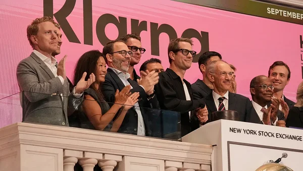 Équipe de Klarna applaudissant sur le balcon de la Bourse de New York.