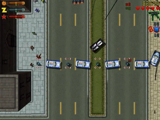 A top-down gameplay screenshot from Grand Theft Auto 2 (1999), showing a street scene with police cars, pedestrians, and the game's HUD elements including health, money, and weapon indicators.