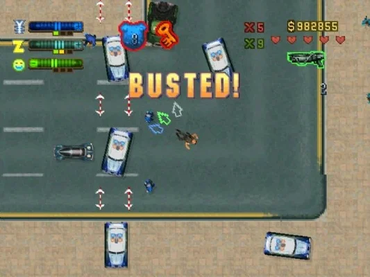 A top-down screenshot from Grand Theft Auto 2 (1999) showing a chaotic street scene with police cars, the player character, and on-screen UI elements including health bars, money counter, weapon icons, and the prominent 'BUSTED!' text indicating arrest. The visual style is pixelated and characteristic of late-90s PC/console games.