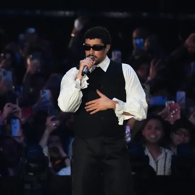 Bad Bunny en concert, captivant son public avec des smartphones allumés.