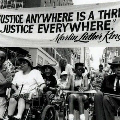 Manifestation historique pour les droits des personnes handicapées à New York, avec une banderole citant Martin Luther King Jr.