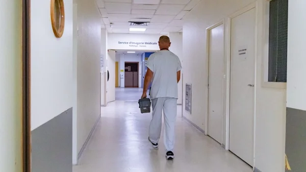 Personnel hospitalier dans un couloir, illustrant le contexte des hôpitaux durant la canicule.