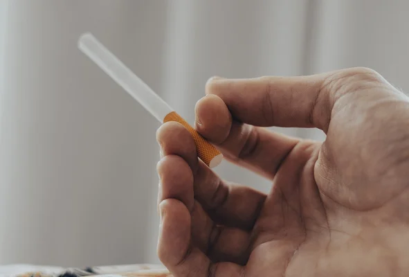 Main tenant une cigarette.