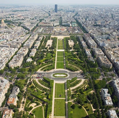 Vue panoramique du Champ-de-Mars depuis la tour Eiffel, avec au loin la tour Montparnasse et le dôme des Invalides.