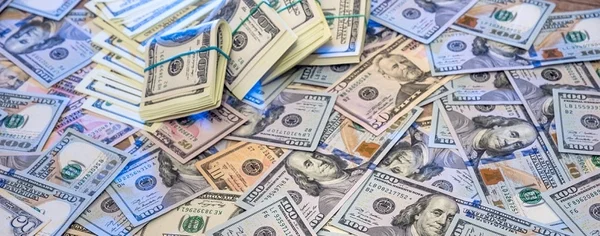 Pile de billets de banque américains illustrant un fonds de 300 milliards de dollars.