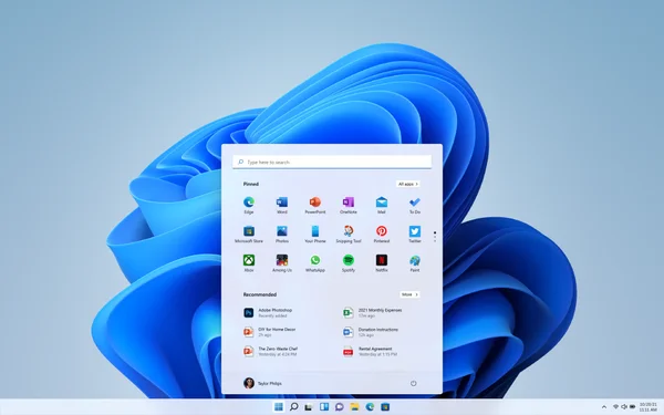 Interface Windows 11 avec le menu Démarrer et le fond d'écran bleu abstrait.