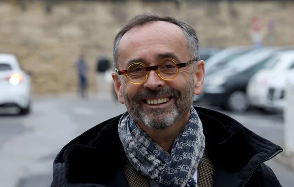Robert Ménard en extérieur, souriant.