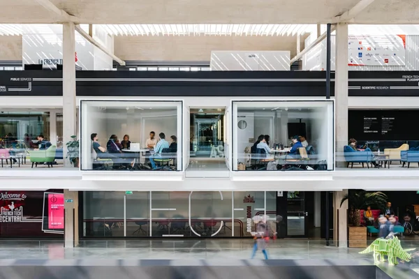 Le hall d'accueil de Station F, avec ses espaces vitrés et son enseigne French Tech Central.