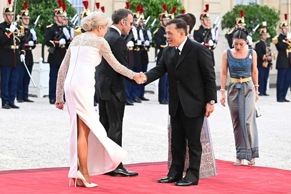 La reine de Thaïlande serrant la main d'Emmanuel Macron lors du dîner d'État en l'honneur du roi Rama X.