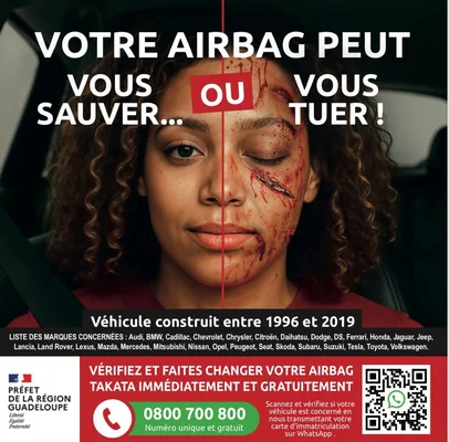 Affiche de prévention sur les airbags Takata montrant une femme blessée par un airbag défectueux, avec les marques concernées et les contacts en Guadeloupe.