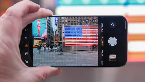 Un smartphone OnePlus photographiant Times Square et le drapeau américain.