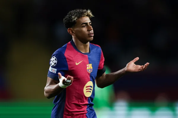 Lamine Yamal sur la pelouse avec le maillot du FC Barcelone.