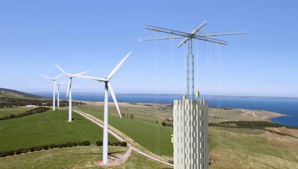 Parc éolien côtier avec une éolienne en construction.