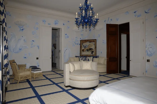 FBI photo of a luxurious bedroom inside Jeffrey Epstein's residence with blue wallpaper.