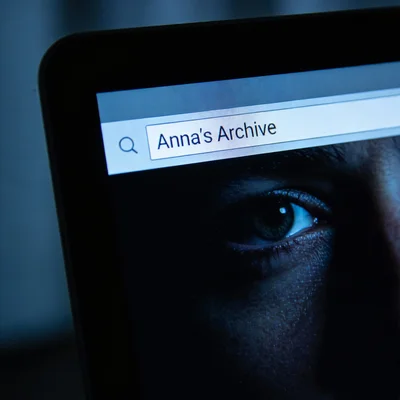 Reflection of eyes on a computer screen showing a search bar.