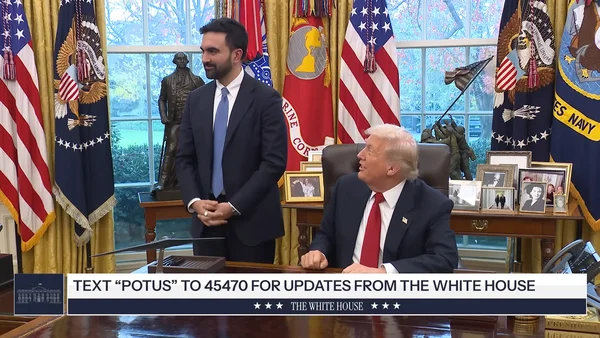 Mayor Zohran Mamdani speaking at a podium outside City Hall.
