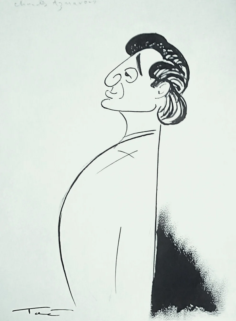 Portrait of Charles Aznavour in a formal suit, posing confidently