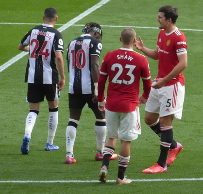 Allan Saint-Maximin running with the ball during a competitive match against Manchester United.