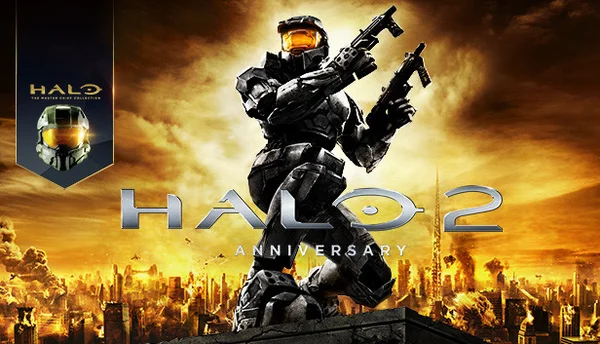 Affiche promotionnelle de Halo 2 Anniversary montrant le Major Master Chief en armure verte sur un rebord, tenant deux armes, avec une ville en feu en arrière-plan et le titre du jeu en grands caractères.