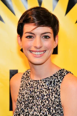 Anne Hathaway souriante, les cheveux courts, portant un haut sans manches a motif noir et blanc, photographiee lors de la premiere du film ELSA & FRED au Festival du film de Miami en 2014.