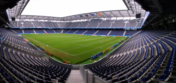Vue panoramique de la Red Bull Arena de Salzbourg, stade vide avec sa pelouse verte, ses tribunes bleues et sa grande structure de toit, lieu de la Supercoupe d'Europe 2026.
