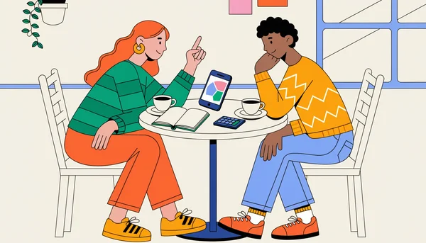 Jeune couple attablé dans un café, un téléphone entre eux affichant un diagramme de partage de dépenses à trois couleurs, avec un carnet ouvert, une calculatrice et deux tasses de café sur la table, en train de répartir ensemble les charges communes du mois.