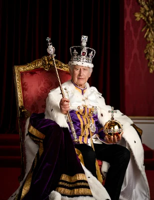 Portrait officiel du roi Charles III assis sur un trône, portant la couronne impériale d'État et les robes royales, tenant le sceptre et l'orbe, lors de son couronnement.