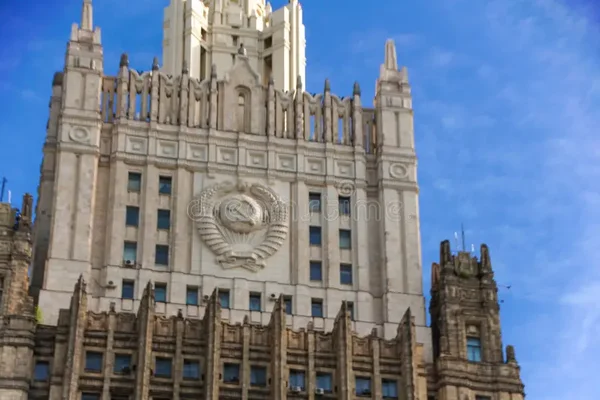 Le bâtiment du ministère de la Santé de la Fédération de Russie, vue de sa partie supérieure, montre une façade stalinienne avec un emblème soviétique et des détails architecturaux sous un ciel bleu.
