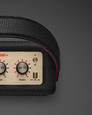 Gros plan sur le panneau de contrôle de l'enceinte Marshall Stockwell III en noir, montrant les molettes de réglage du bass et du treble en finition or brossé.
