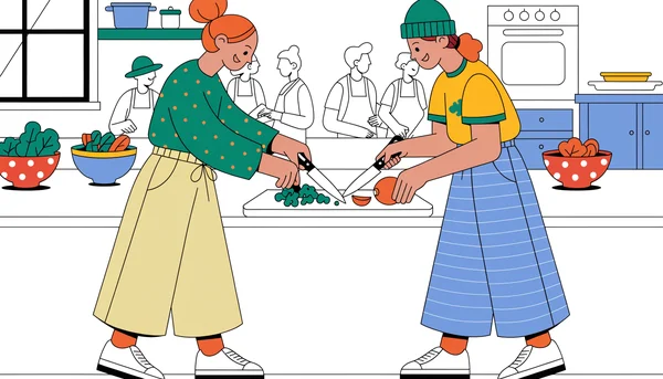 Deux adultes suivent un cours de cuisine hebdomadaire, côte à côte et en train de collaborer, illustrant la stratégie des activités récurrentes pour créer de nouvelles amitiés dans la vie active.
