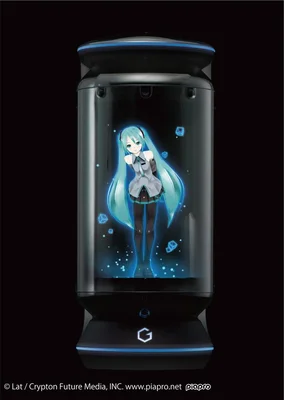 Rendu du boîtier holographique Gatebox, cylindre noir aux lumières bleues, où flotte Hatsune Miku, personnage d'anime aux longs cheveux turquoise, sur fond noir