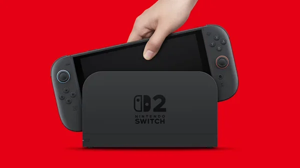 Une main insère une console Nintendo Switch 2 noire dans son dock assorti, sur fond rouge uni : la question technique n'est plus le principal obstacle avancé contre un portage de Palworld.